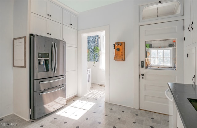 kitchen with white cabinets and stainless steel fridge with ice dispenser