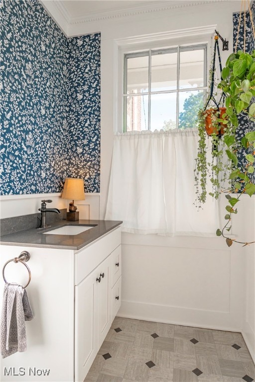 bathroom featuring vanity and ornamental molding