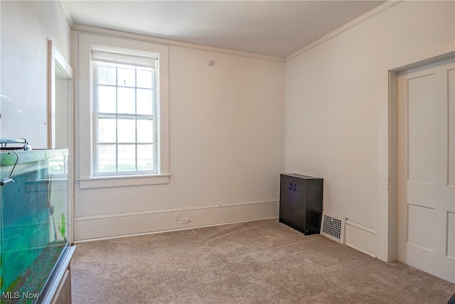 spare room with crown molding and light carpet