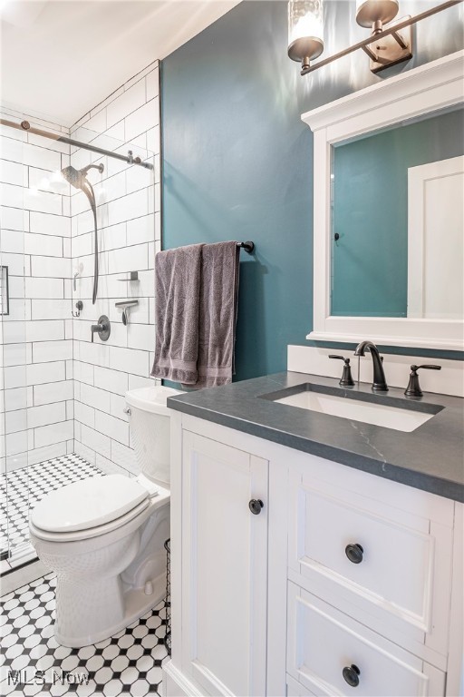 bathroom featuring vanity, toilet, and an enclosed shower