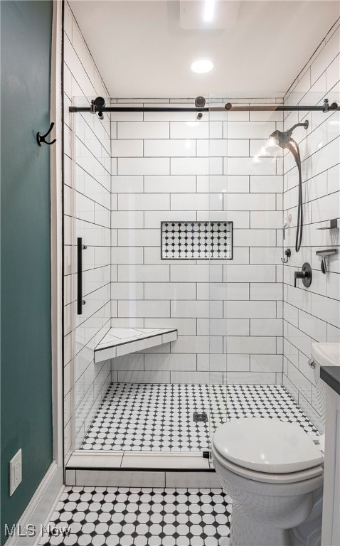 bathroom featuring an enclosed shower, vanity, and toilet