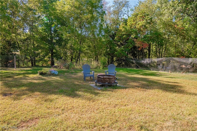 view of yard with an outdoor fire pit