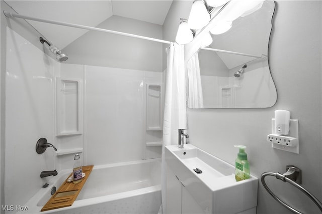 bathroom featuring vaulted ceiling, shower / bath combo, and vanity