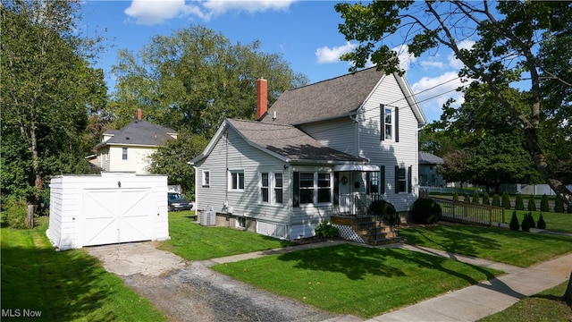 exterior space featuring a front yard, a shed, and central AC