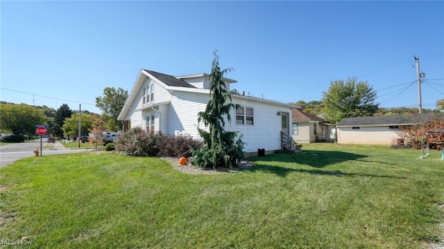 view of property exterior featuring a lawn