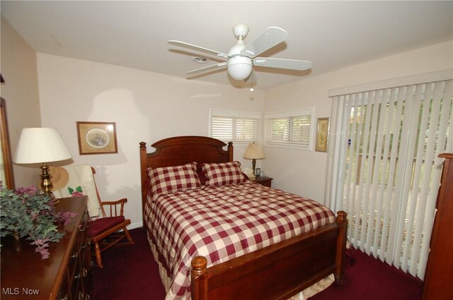 bedroom featuring dark carpet and ceiling fan