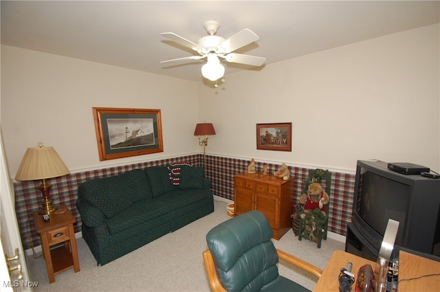 carpeted living room with ceiling fan