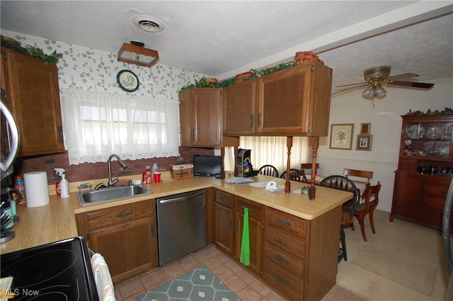 kitchen with range, ceiling fan, stainless steel dishwasher, sink, and kitchen peninsula