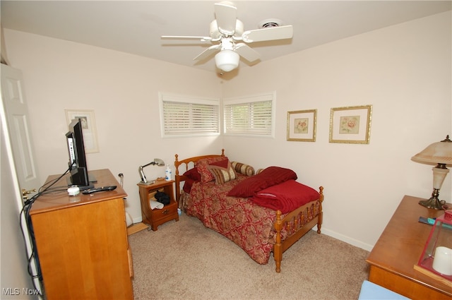 bedroom with ceiling fan and light carpet