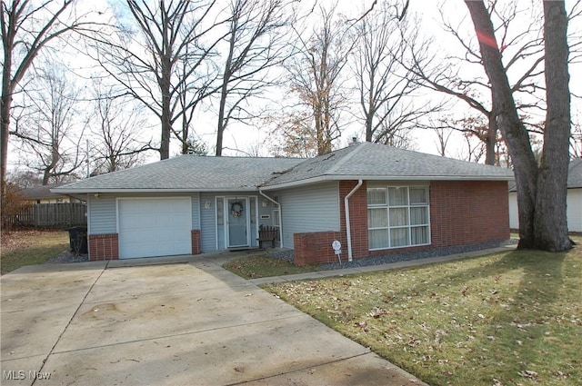 ranch-style house featuring an attached garage, a front lawn, concrete driveway, and brick siding