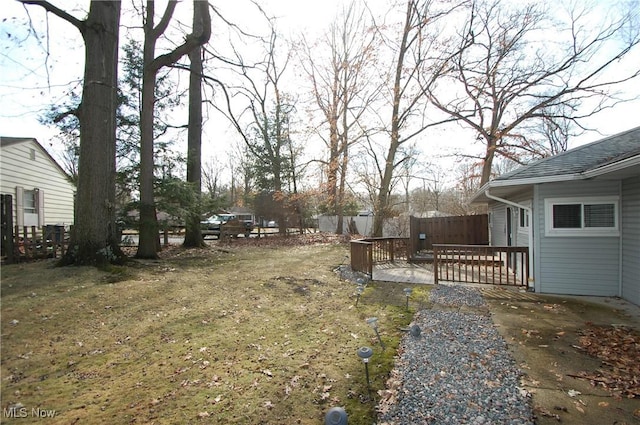 view of yard with a deck and fence