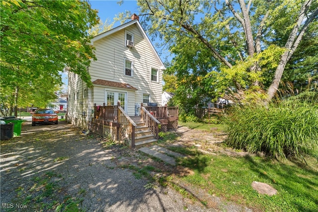 back of house with a wooden deck