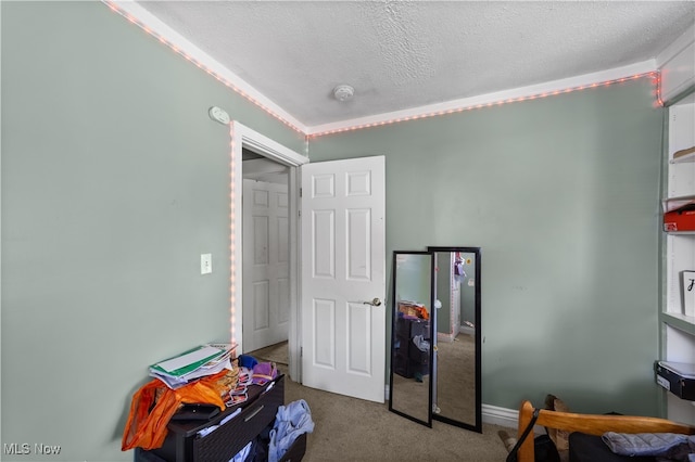 carpeted bedroom featuring a textured ceiling