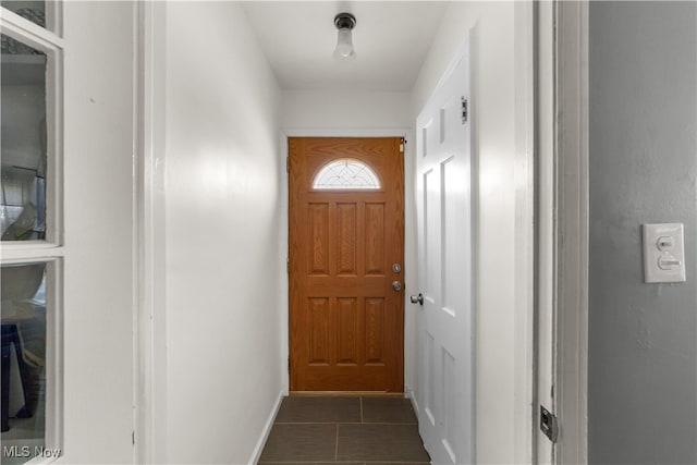 doorway with dark tile patterned flooring