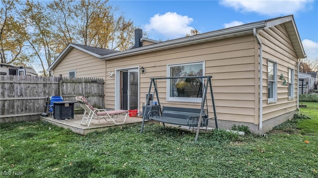 back of house featuring a yard and a deck