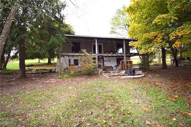 back of house with a lawn