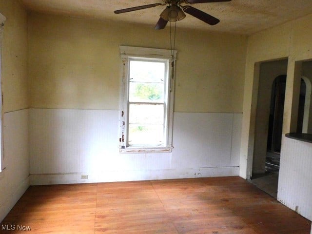 spare room with ceiling fan and wood-type flooring