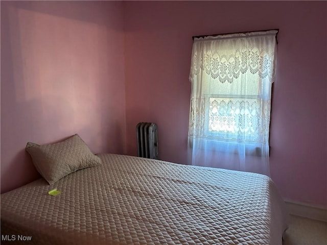 bedroom featuring radiator