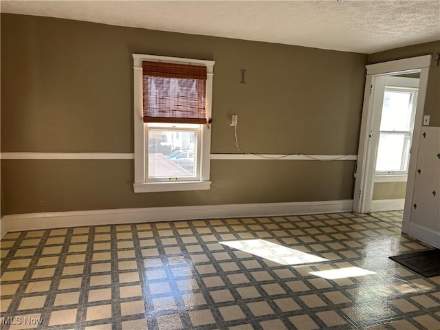 spare room with a textured ceiling