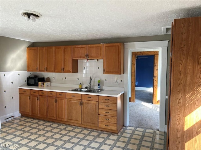 kitchen with sink and a textured ceiling