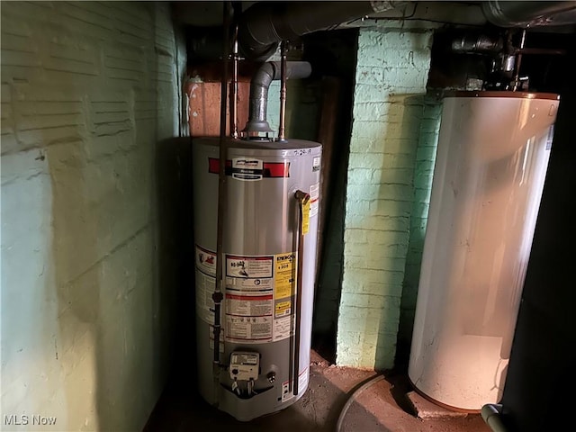 utility room with water heater and gas water heater