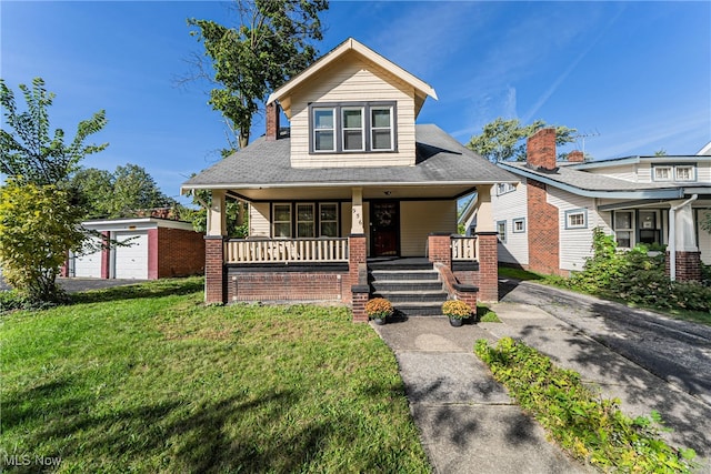 view of front of house featuring a garage, an outdoor structure, a front lawn, and covered porch