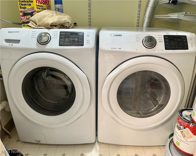 laundry area with washing machine and clothes dryer