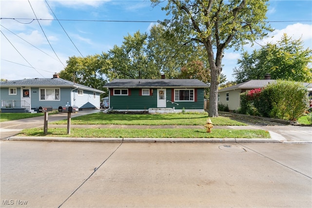 ranch-style home featuring a front yard