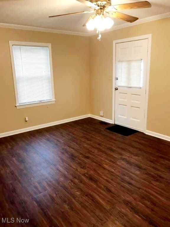 foyer entrance with ornamental molding, ceiling fan, and dark hardwood / wood-style flooring