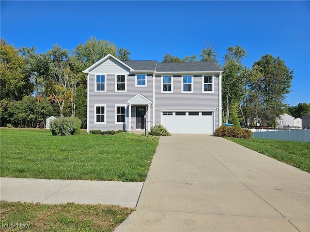 view of front of house with a front yard and a garage