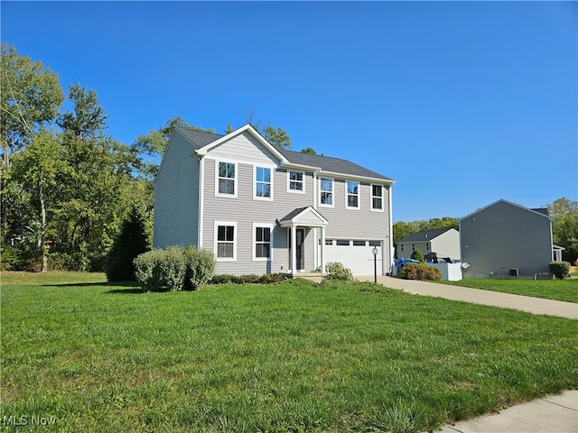 view of front of home featuring a front lawn and a garage