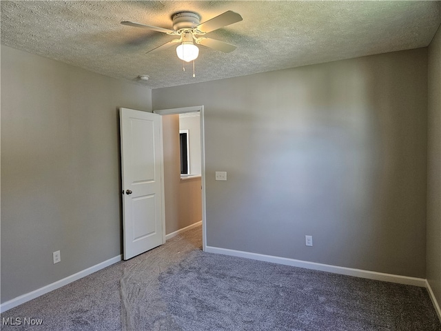 unfurnished room with ceiling fan, a textured ceiling, and carpet floors