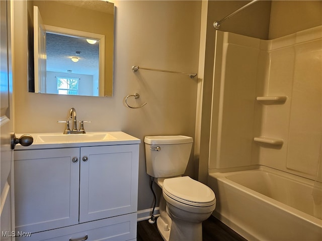 full bathroom with a textured ceiling, hardwood / wood-style flooring, toilet, vanity, and washtub / shower combination