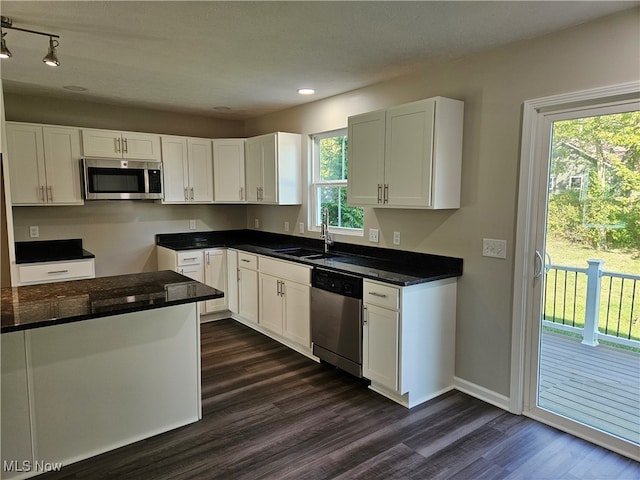 kitchen with sink, white cabinetry, stainless steel appliances, and plenty of natural light