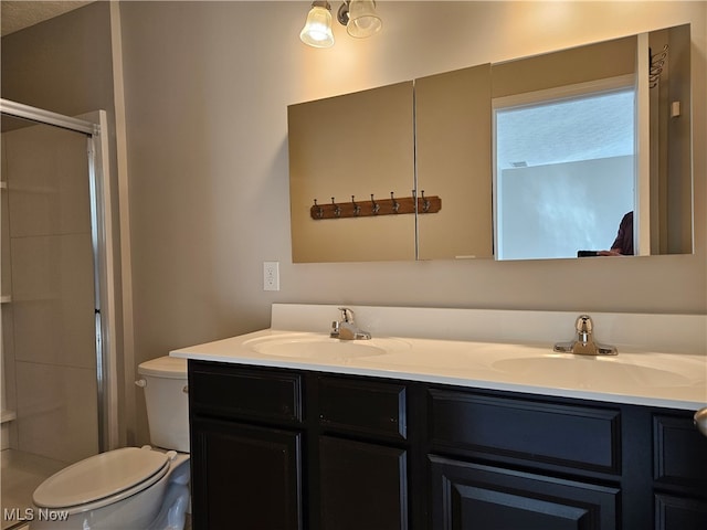 bathroom featuring vanity, toilet, and walk in shower