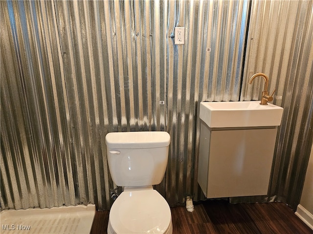 bathroom with vanity, wood-type flooring, and toilet