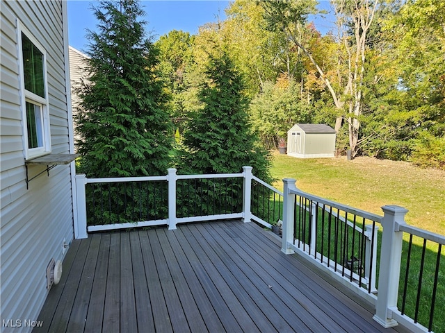 wooden deck with a storage shed and a yard