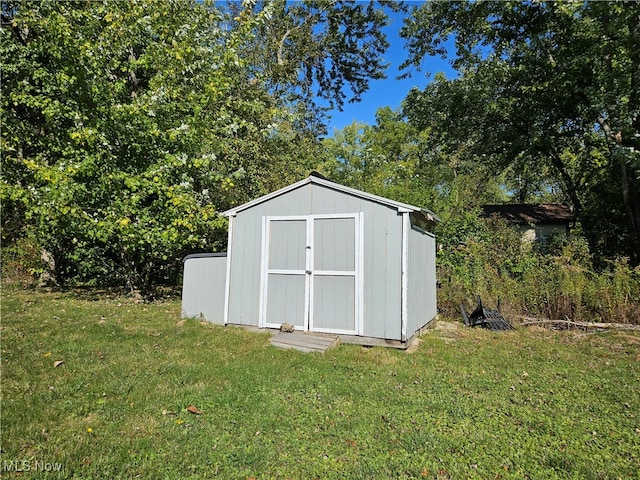 view of outbuilding featuring a yard