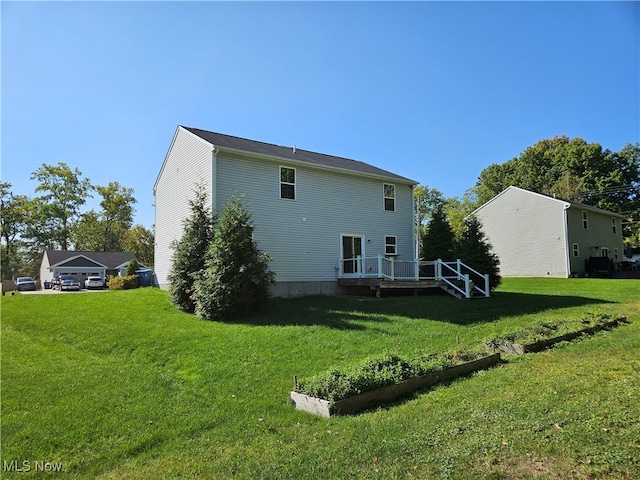 rear view of house featuring a yard