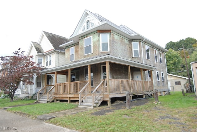 view of front of house featuring a front lawn and covered porch