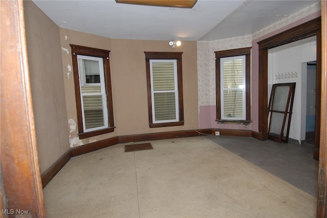 unfurnished room with concrete floors