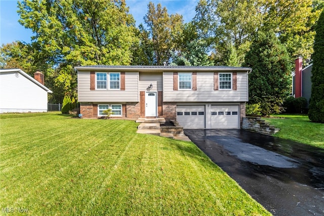 raised ranch featuring a front lawn and a garage