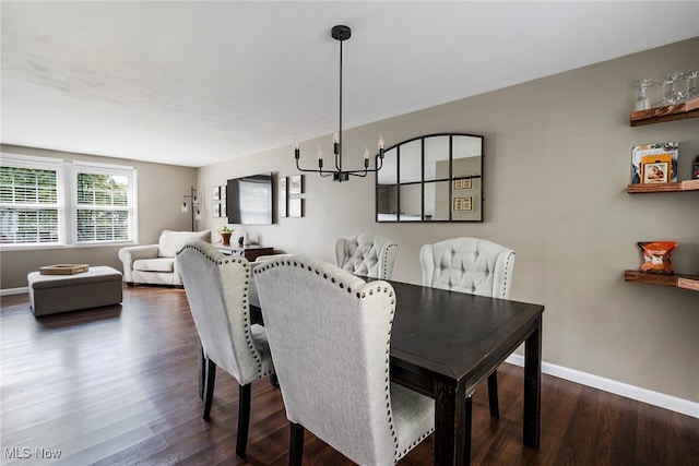 dining space with a notable chandelier and dark wood-type flooring