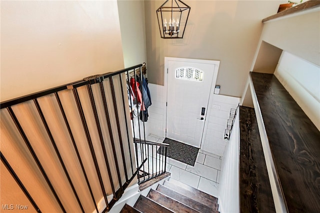 foyer featuring hardwood / wood-style floors and a notable chandelier