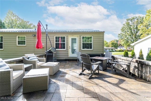 view of patio with an outdoor fire pit and area for grilling