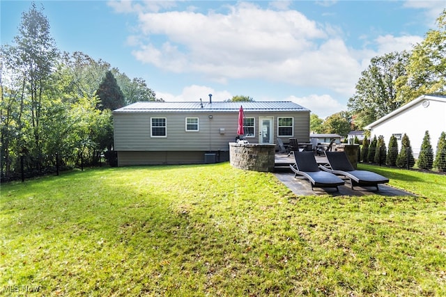 back of house featuring a yard and a patio