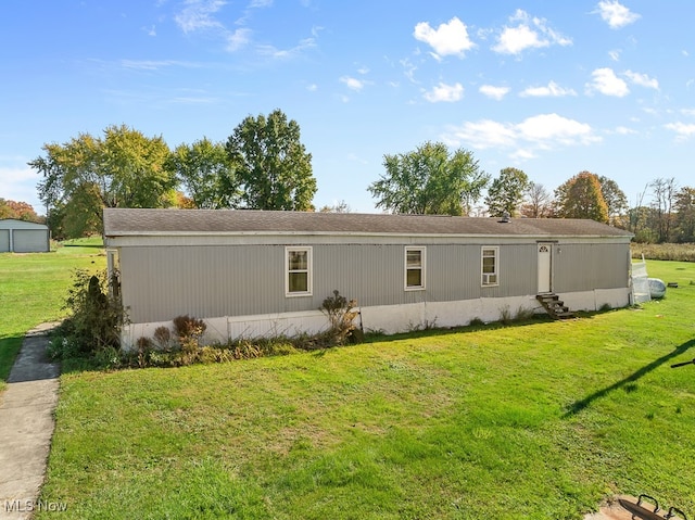 rear view of property featuring a yard