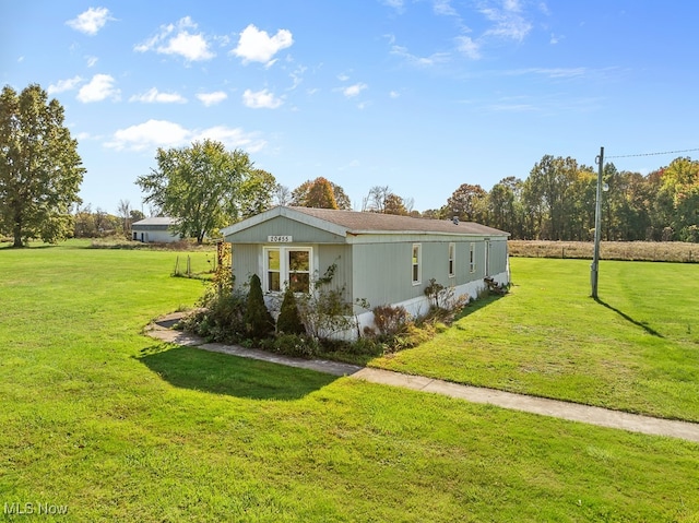 view of side of home featuring a lawn