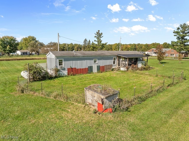 back of property with a lawn