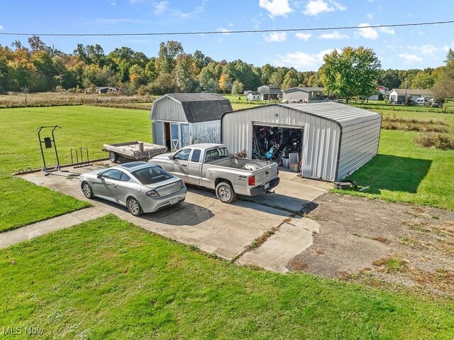 view of vehicle parking with a yard and a garage